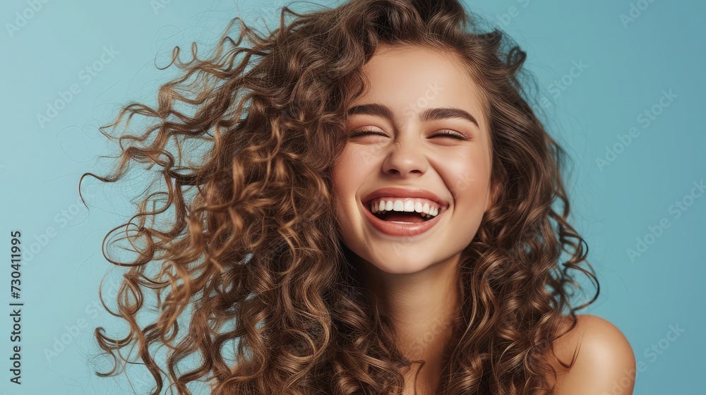 Beautiful laughing brunette model girl with long curly hair . Smiling woman hairstyle wavy curls . Fashion , beauty and makeup portrait