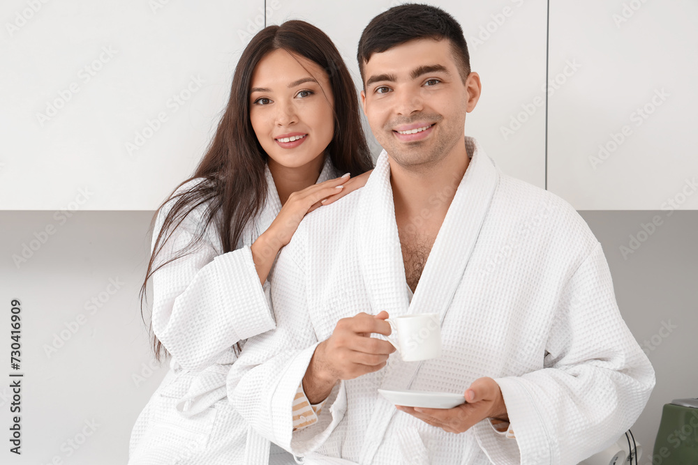 Happy young couple drinking coffee in kitchen Happy young couple drinking coffee in kitchen