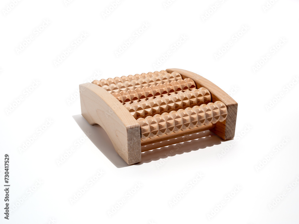 Wooden foot massager on a white background. Wooden massager close-up. Wooden foot massager on a white background. Wooden massager close-up.