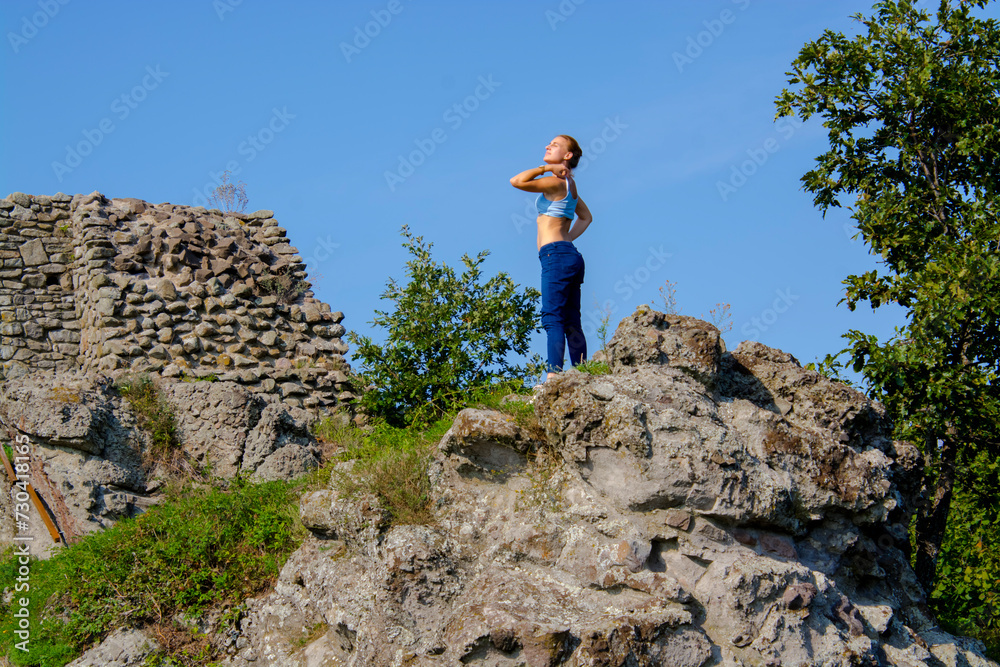 Ruins of the Medieval Fortress of Dregely with a young woman