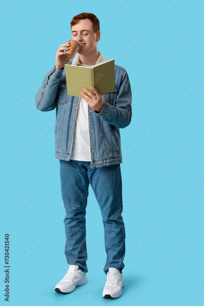 Young man reading book and drinking coffee on color background Young man reading book and drinking coffee on color background