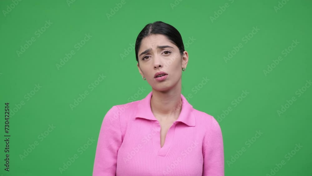 Surprised upset Caucasian young woman is disappointed and dissatisfied on a green background. Surprise, unpleasant surprise, bad news concept. Surprised upset Caucasian young woman is disappointed and dissatisfied on a green background. Surprise, unpleasant surprise, bad news concept.