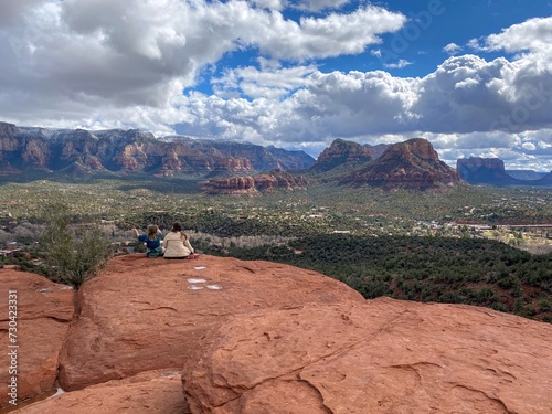 airport, airport mesa, airport mesa sedona vortex, A woman sitting with her daughter at the Airport Mesa Sedona vortex  overlooking Sedona, Arizona on a beautiful sunny winter day, with the red rocks  photo