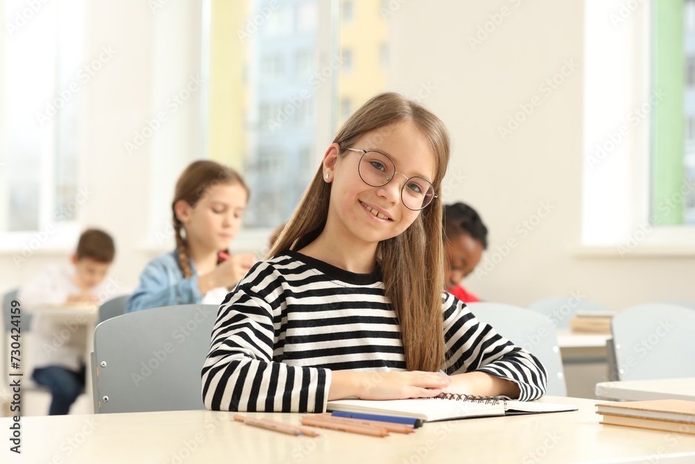 Portrait of smiling little girl studying in classroom at school Portrait of smiling little girl studying in classroom at school