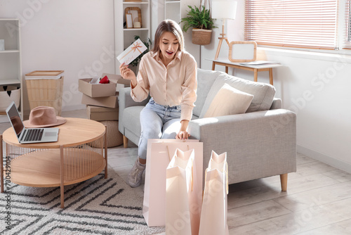 Young woman with gift card ...
