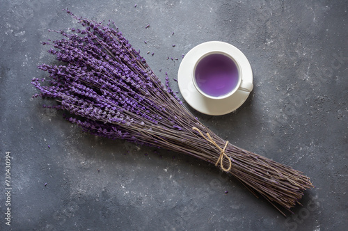 Cup of lavender tea with dried lavender flowers on rustic table, herbal relaxing tea. Lavendula oleum