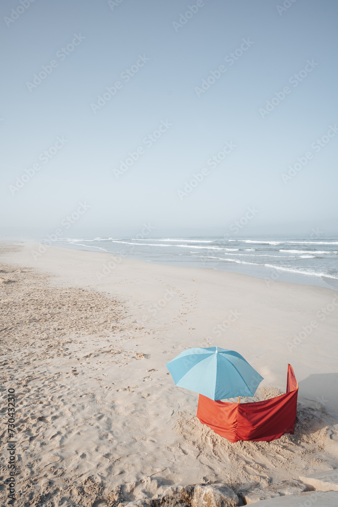 blue umbrella on a sandy beach blue umbrella on a sandy beach