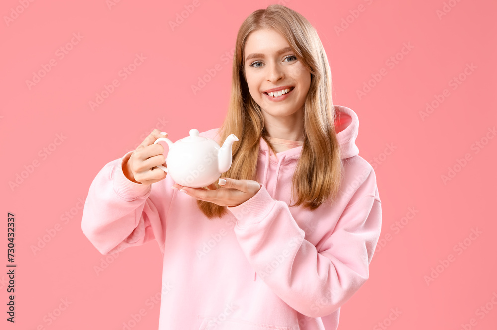 Beautiful young woman with teapot on pink background Beautiful young woman with teapot on pink background