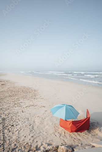 blue umbrella on a sandy beach