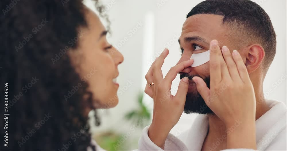 Couple, bathroom and eye patch in skincare for morning, grooming or hygiene together at home. Woman applying face pad or mask on man for beauty, anti aging or facial treatment in health and wellness Couple, bathroom and eye patch in skincare for morning, grooming or hygiene together at home. Woman applying face pad or mask on man for beauty, anti aging or facial treatment in health and wellness