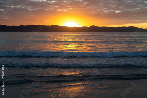 Sunset over Cape Reinga and the ocean in Spirits Bay, Northland, New Zealand. © Zenstratus