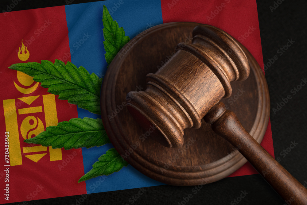 Judicial wooden gavel, fresh hemp leaf and Mongolia flag. Illegal sale and distribution of marijuana