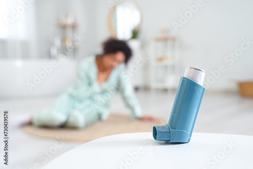 Asthma inhaler on table of woman in bathroom  closeup