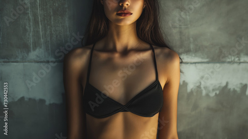 Young woman in underwear bra. Cropped studio photo.