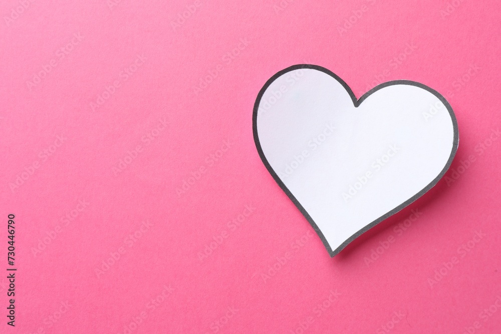 White paper heart on pink background, top view. Space for text