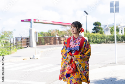                                                                                                                                A young Japanese woman in her 20s in Ryukyu dress at a place with a view of the sea on Umikaji Terrace in Senaga  Tomigusuku City  Okinawa Prefecture