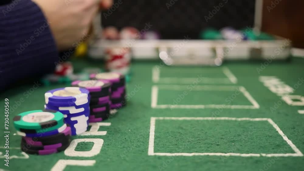 Stacks of poker chips are on table during two men play Stacks of poker chips are on table during two men play