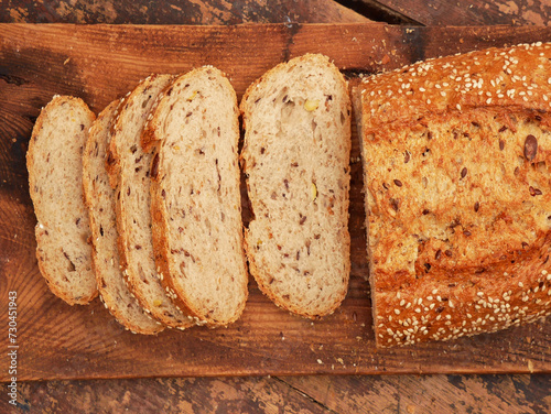 Sourdough wheat-rye bread with brown flaxseed, sunflower, sesame, soya and broken wheat grains. Close-up view from above.