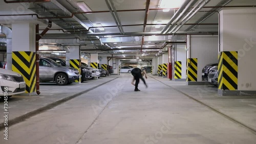 Wallpaper Mural Young man runs and makes somersault at underground parking. Slow motion Torontodigital.ca