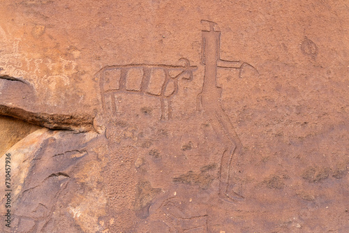 Ancient petroglyph of a man and an animal at the Jubbah rock art site at Ob Sinman Mountain. photo