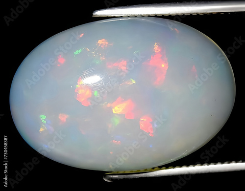 natural rainbow multi color opal gem on the background photo