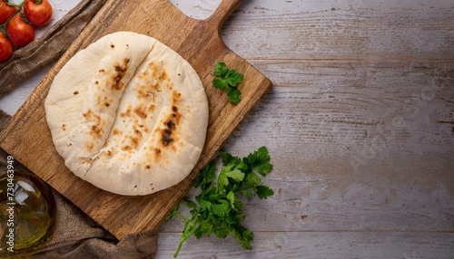 Homemade pita bread on neutral background with copy space