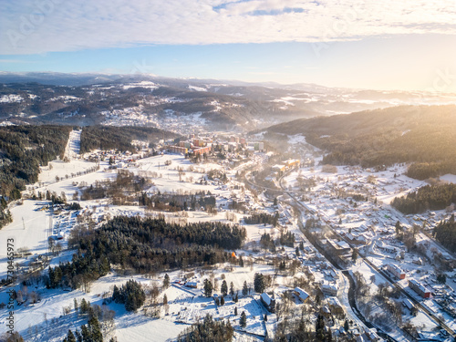 Tanvald in wintertime. Small town in Jizera Mountains, Czechia. Aerial photography from above.