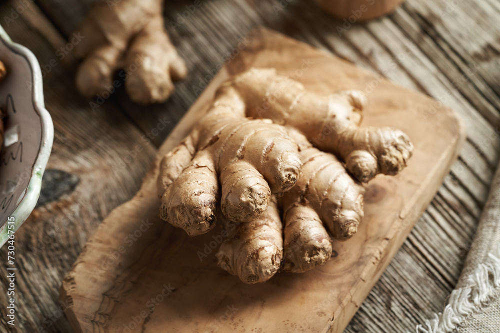 Fresh ginger root on a wooden table, closeup