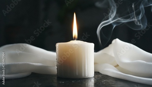 White burning candle on a black background 