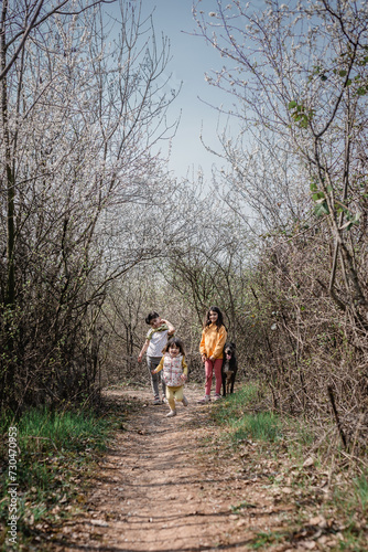 three children running on the country road with their dog © Victoria