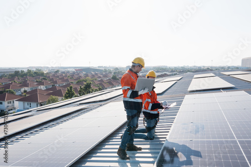 Engineering technician professional trained in skills and techniques installing solar photovoltaic panels system, engineer service check installation solar cell on factory roof, technology solar cell