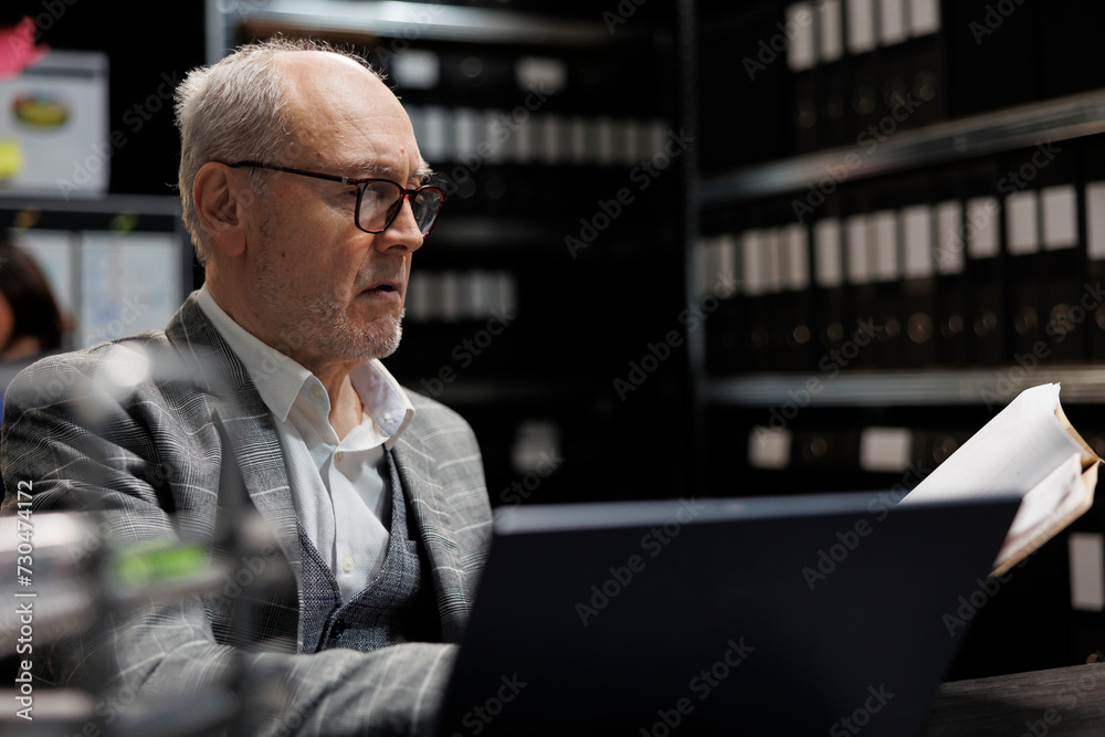Accountancy businessman checking bookkeeping analytical data paperwork. Administration employee in business company file cabinet repository filled with flowcharts and folders Accountancy businessman checking bookkeeping analytical data paperwork. Administration employee in business company file cabinet repository filled with flowcharts and folders