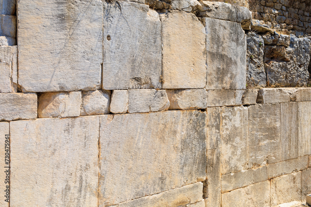 Antique wall made of huge blocks with minimal gaps. Background with selective focus and copy space Antique wall made of huge blocks with minimal gaps. Background with selective focus and copy space