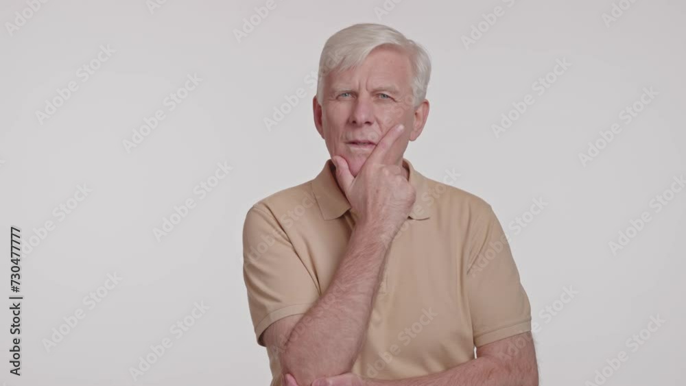 gray haired man in a thoughtful pose, hand at chin studio shot gray haired man in a thoughtful pose, hand at chin studio shot