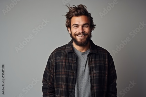 Portrait of a handsome young man with trendy hairstyle and beard