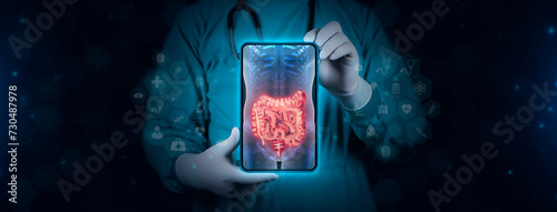 Color image of the large and small intestine on an x-ray. The doctor studies and analyzes the gastrointestinal tract. Scene of a doctor with tablet on digital technology background.