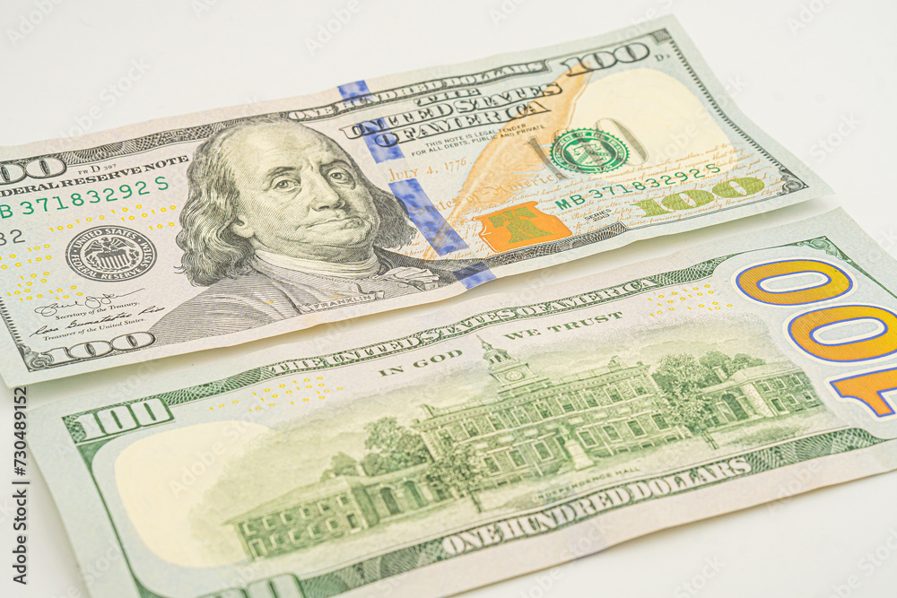 A few 100 dollar bills with the back side lying around. The back of a One hundred dollar bill A few 100 dollar bills with the back side lying around. The back of a One hundred dollar bill