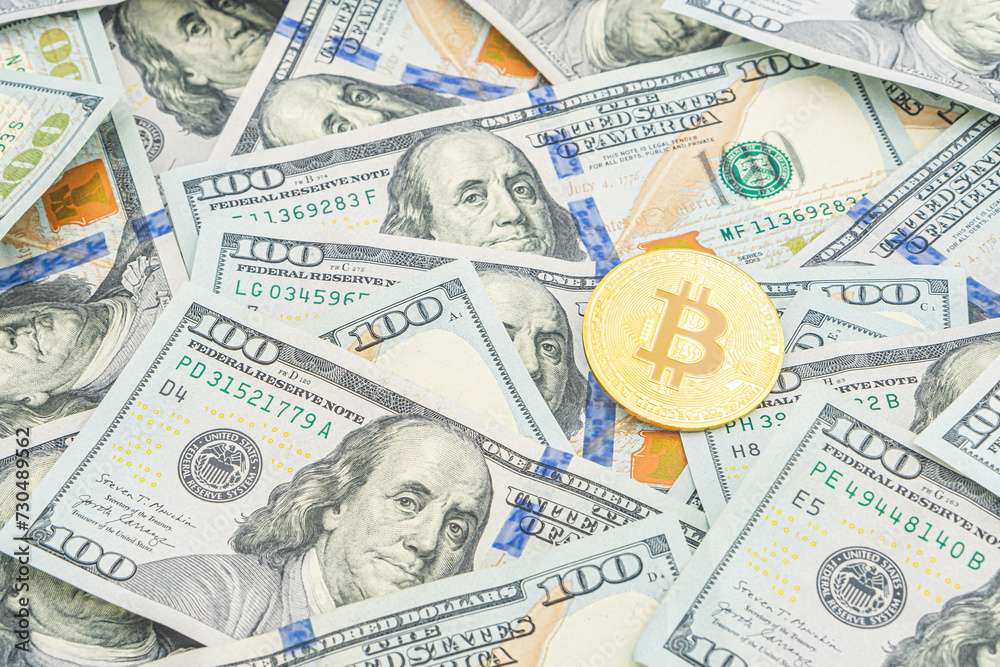 Gold Bitcoin on hundred dollars bills. Golden symbolic coin Bitcoin on banknotes of one hundred dollars. Cryptocurrency on US dollar bills. Digital modern method of payment. Exchange bitcoin cash Gold Bitcoin on hundred dollars bills. Golden symbolic coin Bitcoin on banknotes of one hundred dollars. Cryptocurrency on US dollar bills. Digital modern method of payment. Exchange bitcoin cash