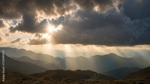 Sun Shining Through Clouds Over Mountains