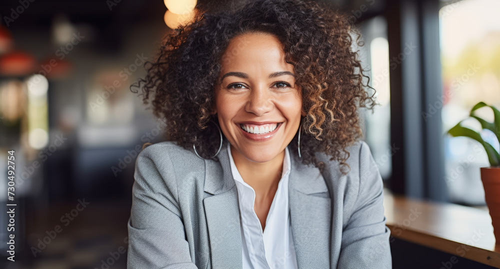 a smiling woman with a business jacket in an office a smiling woman with a business jacket in an office
