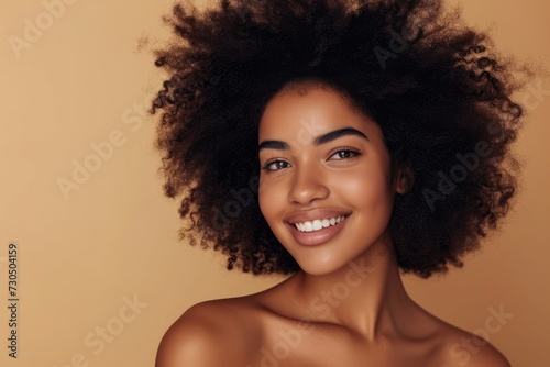 Smiling beautiful African American woman with clean healthy skin and curly black hair