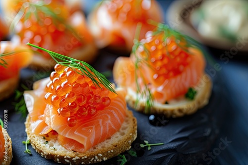 Smoked salmon bites topped with lumpfish caviar photo