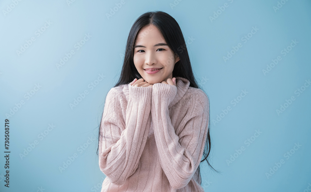Portrait of young beautiful asian woman relax isolated on blue. Smile happy asian girl hands cover face wear winter cloth. Beauty treatment perfect clear skin japanese woman makeup winter hygge banner Portrait of young beautiful asian woman relax isolated on blue. Smile happy asian girl hands cover face wear winter cloth. Beauty treatment perfect clear skin japanese woman makeup winter hygge banner