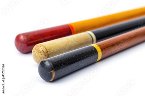 billiard cues on a white surface