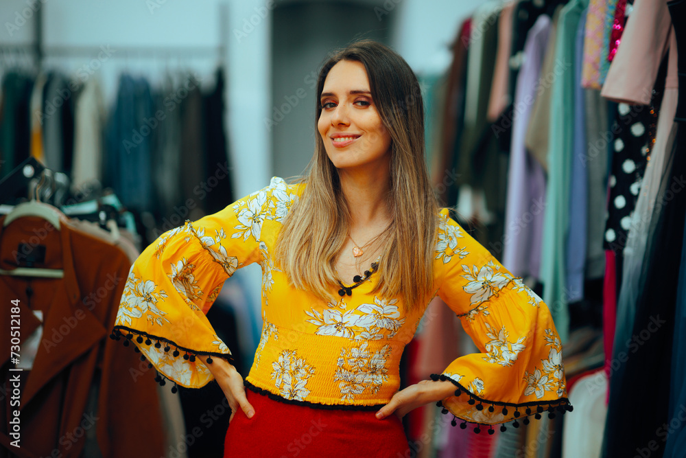 Woman Wearing a Beautiful Floral Yellow Top . Lady choosing a colorful top in a clothing store 
