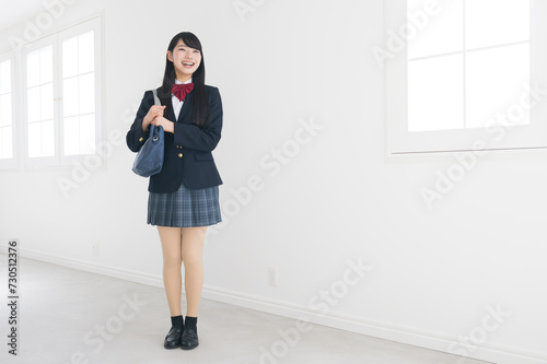 Full body of high school girl looking up on easy-to-use white background photo