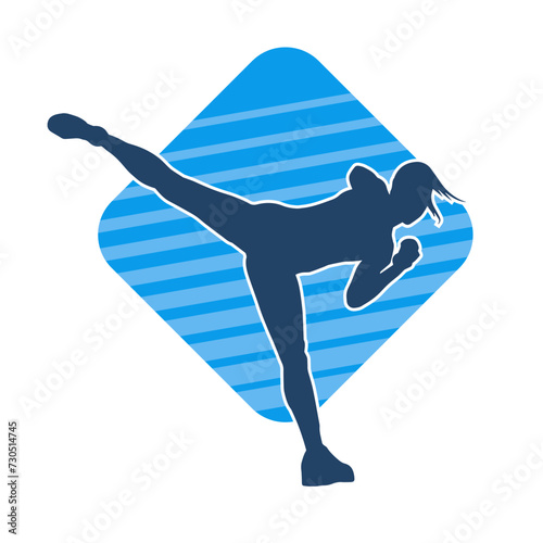 Silhouette of a female kickboxer athlete in action pose. Silhouette of a sporty woman doing kicking pose.