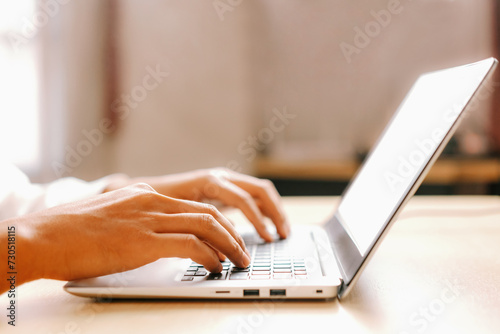 Businessman hand typing on computer keyboard of a laptop computer in office. Business and finance concept. uds