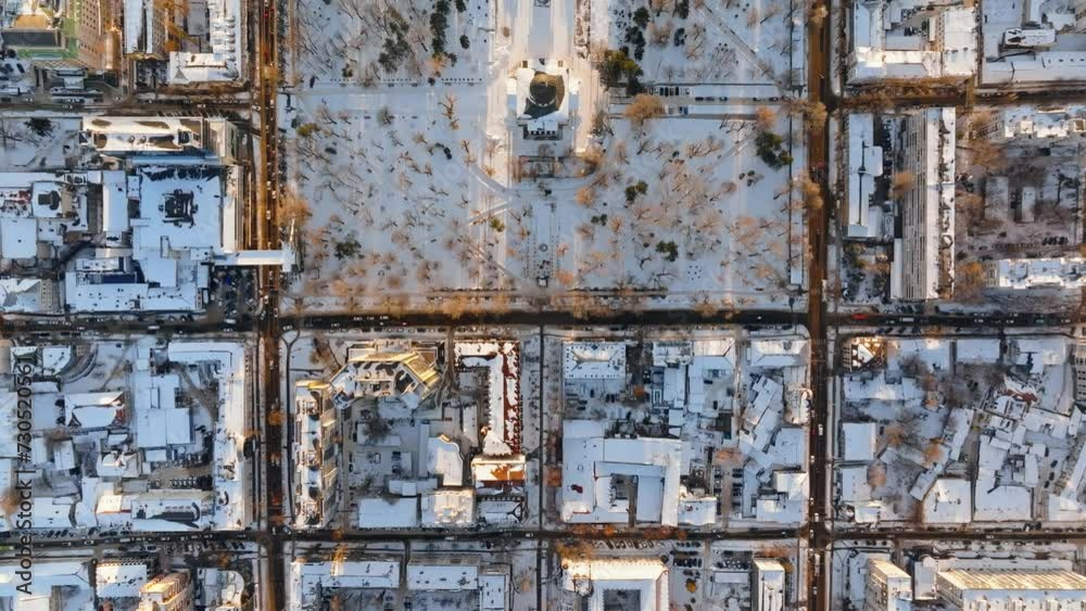 Aerial drone top view of the Bell tower and the Metropolitan Cathedral of Christ's Nativity. City center covered in snow at sunset in Chisinau, Moldova Aerial drone top view of the Bell tower and the Metropolitan Cathedral of Christ's Nativity. City center covered in snow at sunset in Chisinau, Moldova