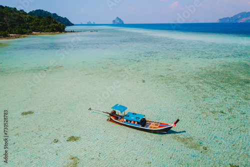 Fototapeta Naklejka Na Ścianę i Meble -  longtail boat in the turqouse colored ocean with clear water at Koh Kradan Thailand